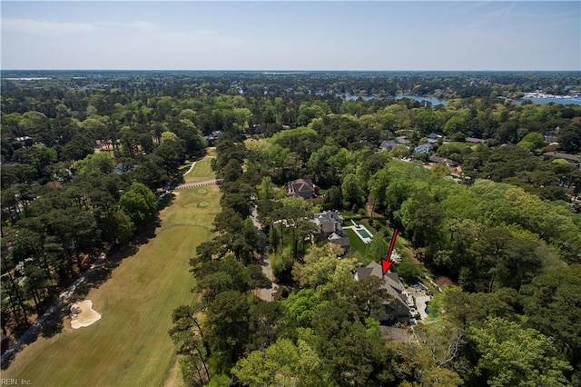birds eye view of property with a view of trees and golf course view