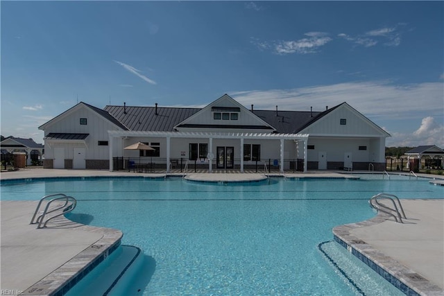 pool featuring fence and a patio