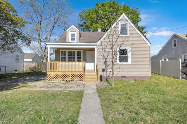bungalow-style house with fence, a front lawn, crawl space, covered porch, and roof with shingles