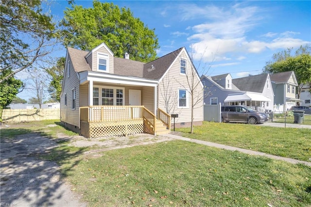 bungalow-style house with a porch, crawl space, a front lawn, and fence