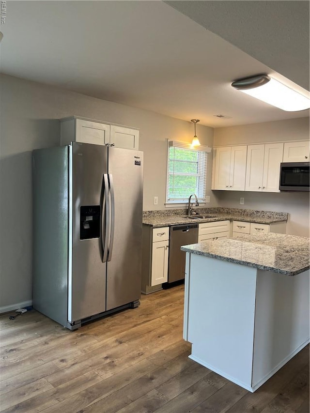 420 Cottonwood St, Newport News, VA 23608 - kitchen featuring white cabinets, a sink, appliances with stainless steel finishes, light stone countertops, and wood finished floors