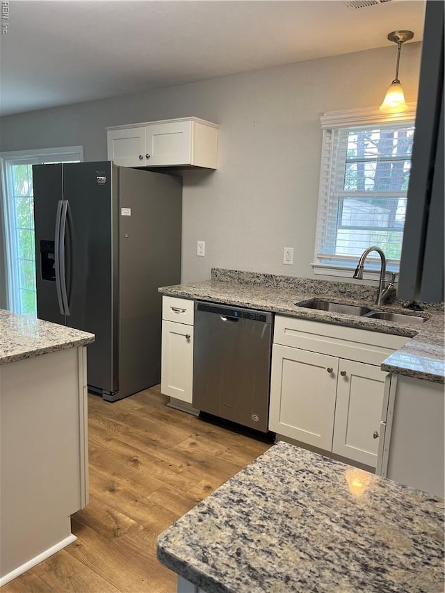 420 Cottonwood St, Newport News, VA 23608 - kitchen with light stone counters, a sink, light wood-type flooring, dishwasher, and fridge with ice dispenser