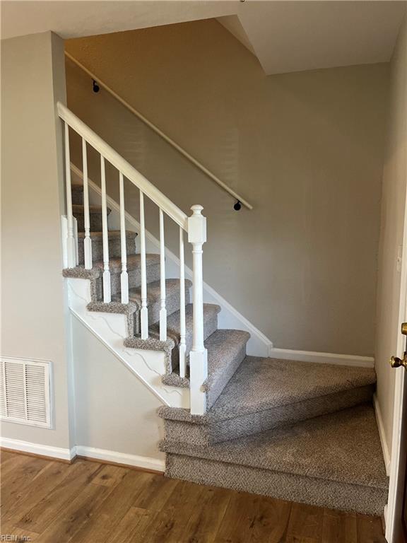 420 Cottonwood St, Newport News, VA 23608 - staircase with baseboards, visible vents, and wood finished floors