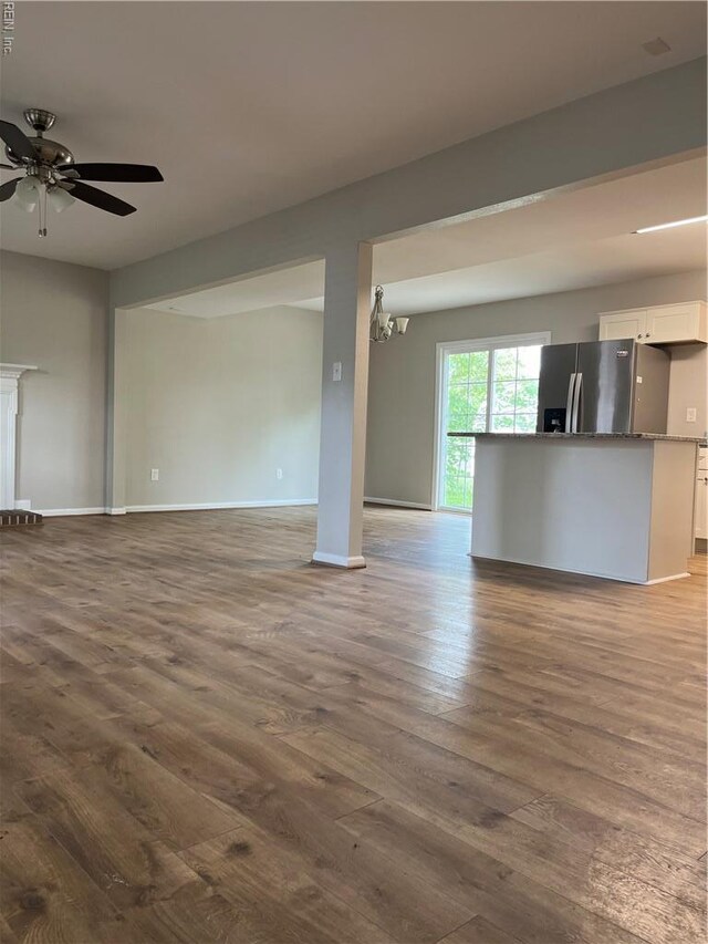 420 Cottonwood St, Newport News, VA 23608 - unfurnished living room with baseboards, wood finished floors, and ceiling fan with notable chandelier