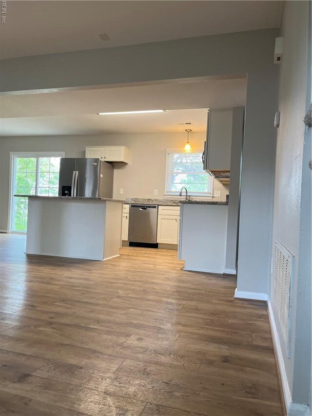 420 Cottonwood St, Newport News, VA 23608 - kitchen with a sink, stainless steel appliances, wood-type flooring, visible vents, and white cabinets