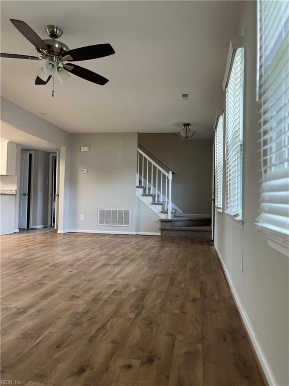 420 Cottonwood St, Newport News, VA 23608 - unfurnished living room with wood finished floors, stairs, baseboards, visible vents, and a ceiling fan