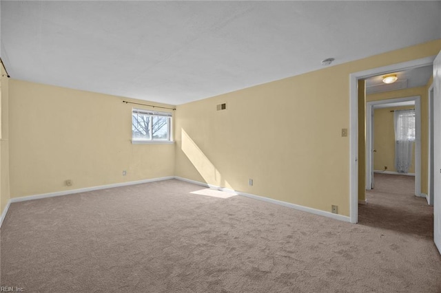 unfurnished room with visible vents, carpet flooring, and baseboards
