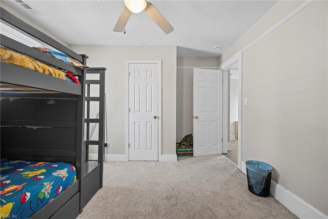 bedroom featuring visible vents, baseboards, carpet floors, and ceiling fan