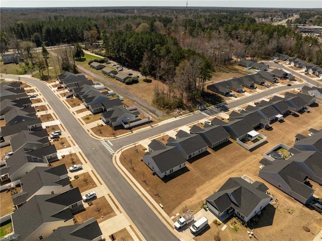 birds eye view of property with a forest view and a residential view