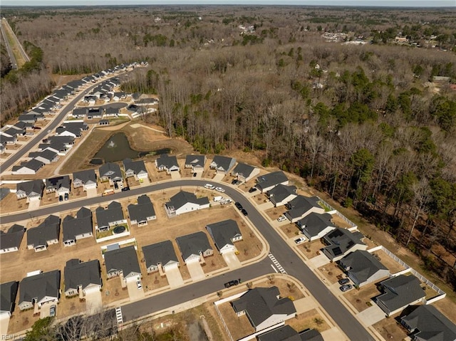 birds eye view of property featuring a forest view and a residential view