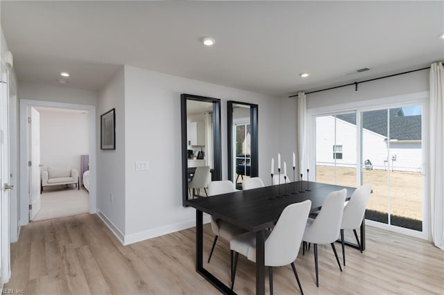 dining space with recessed lighting, light wood-type flooring, visible vents, and baseboards