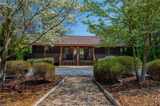 single story home with roof with shingles