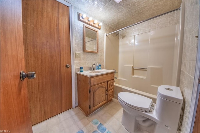 full bathroom with tile walls, shower / bathtub combination, vanity, and toilet