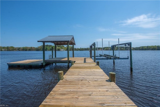 view of dock with boat lift and a water view
