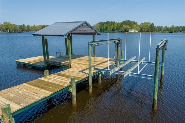 view of dock with boat lift and a water view