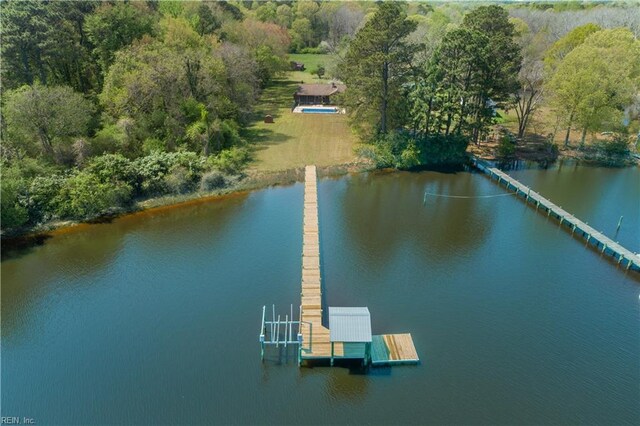 bird's eye view with a water view and a wooded view