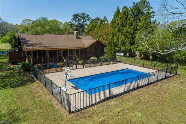 view of swimming pool featuring a yard, a fenced in pool, a patio area, and fence