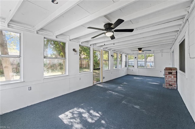 unfurnished sunroom featuring a ceiling fan and beam ceiling
