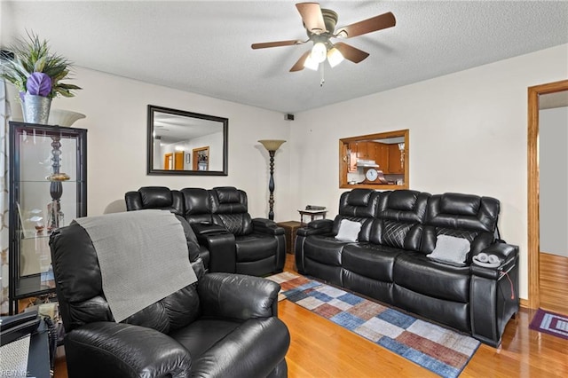 living room featuring wood finished floors and ceiling fan