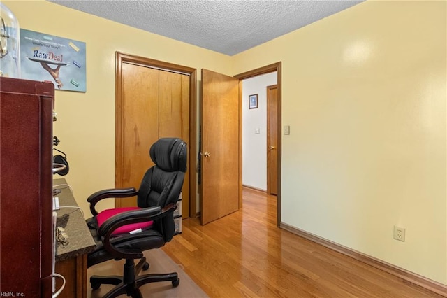 office area featuring wood finished floors and a textured ceiling