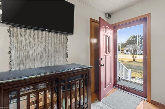 entryway featuring wood finished floors and a textured ceiling
