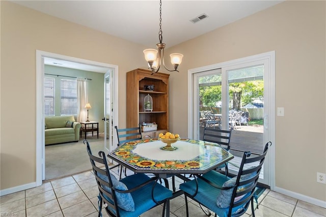 dining space with baseboards, a notable chandelier, visible vents, and light tile patterned floors