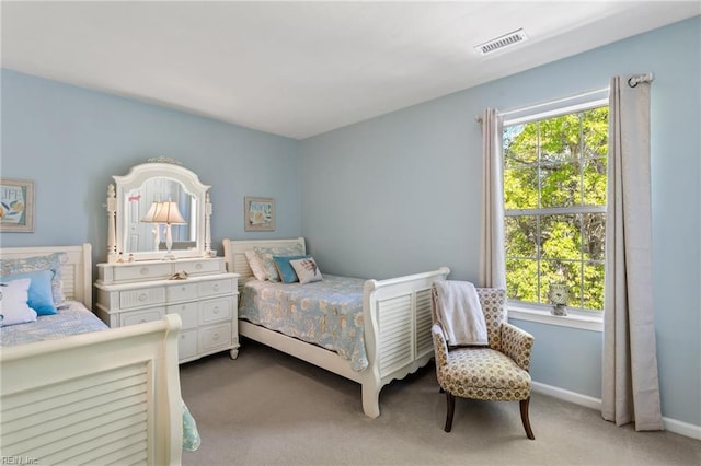 carpeted bedroom featuring visible vents and baseboards