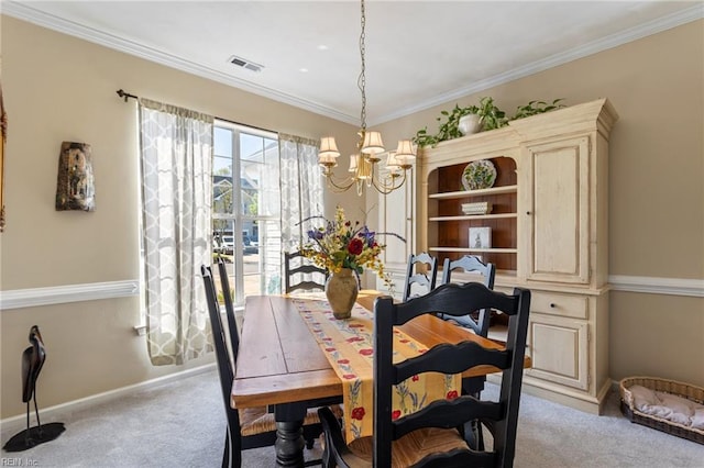 dining room featuring baseboards, visible vents, a notable chandelier, carpet floors, and ornamental molding