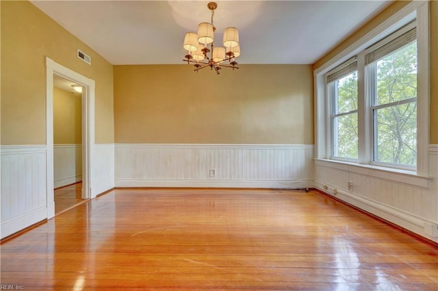 3719 Granby St Unit C-3, Norfolk, VA 23504 - unfurnished room featuring visible vents, a wainscoted wall, hardwood / wood-style flooring, and an inviting chandelier