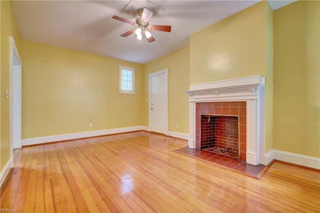 3719 Granby St Unit C-3, Norfolk, VA 23504 - unfurnished living room featuring hardwood / wood-style floors, a tiled fireplace, a ceiling fan, and baseboards