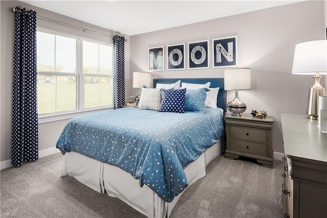 bedroom featuring baseboards and carpet flooring