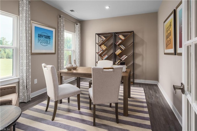 dining room featuring dark wood-type flooring, visible vents, baseboards, and recessed lighting