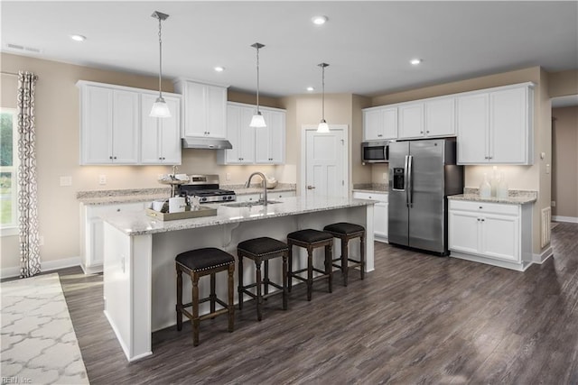 kitchen with a sink, stainless steel appliances, baseboards, under cabinet range hood, and visible vents