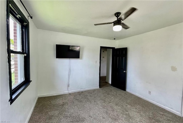 unfurnished bedroom with carpet flooring and baseboards
