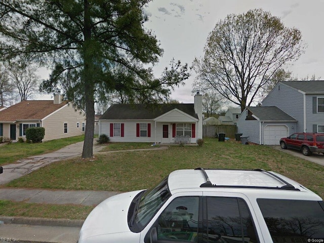 bungalow with a front lawn and fence