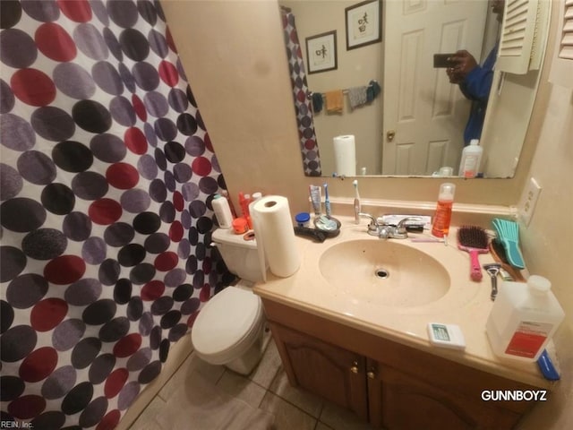 bathroom featuring tile patterned floors, vanity, curtained shower, and toilet
