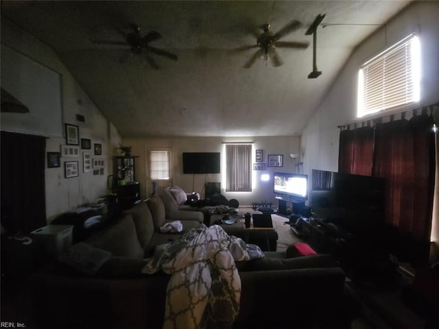 carpeted living room with high vaulted ceiling and a ceiling fan