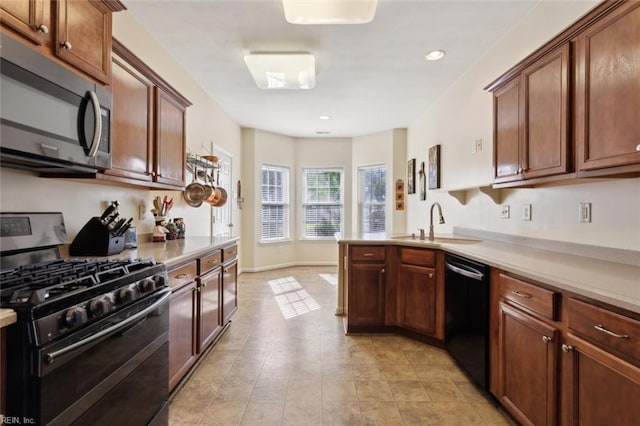 kitchen featuring a peninsula, light countertops, and appliances with stainless steel finishes