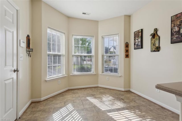 interior space with visible vents, tile patterned flooring, and baseboards