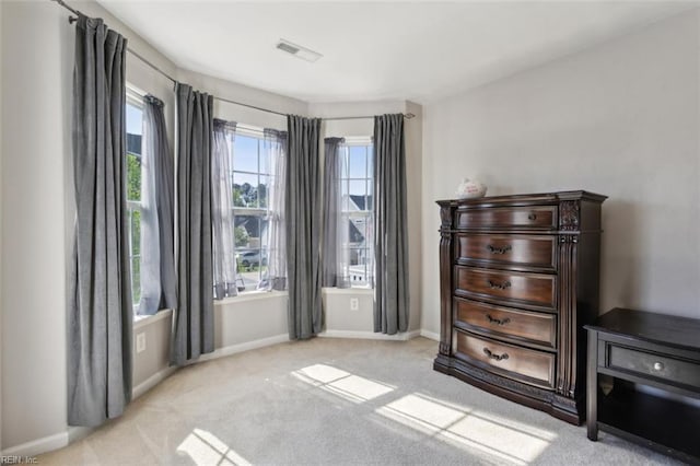 carpeted bedroom featuring baseboards and visible vents