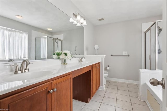 bathroom featuring double vanity, a shower stall, tile patterned floors, and a sink