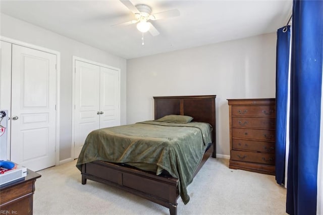 bedroom featuring light colored carpet, ceiling fan, and baseboards