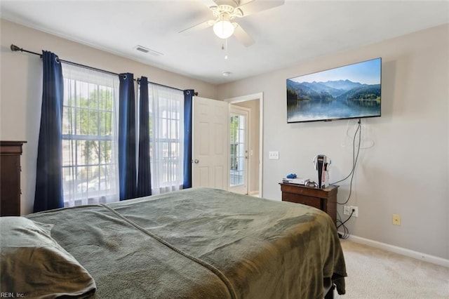 bedroom with light colored carpet, baseboards, multiple windows, and visible vents