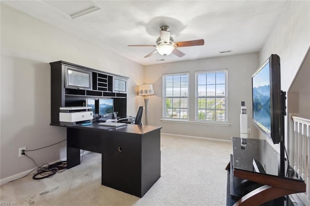 office area featuring light carpet, a ceiling fan, visible vents, and baseboards