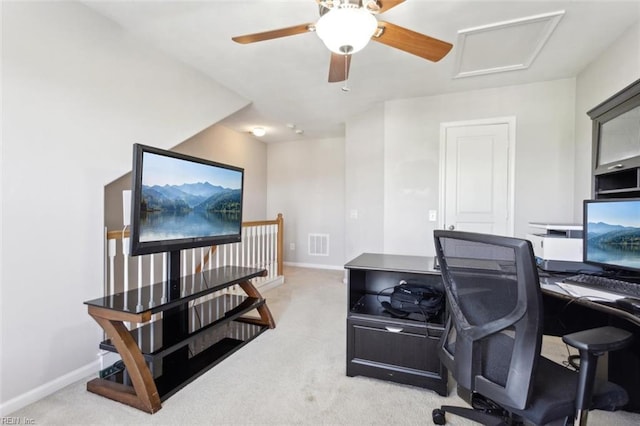 office area with attic access, visible vents, baseboards, and light carpet