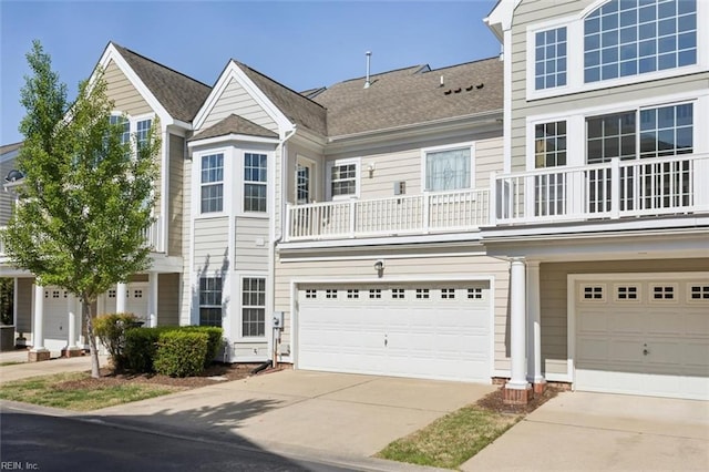 multi unit property featuring an attached garage and driveway