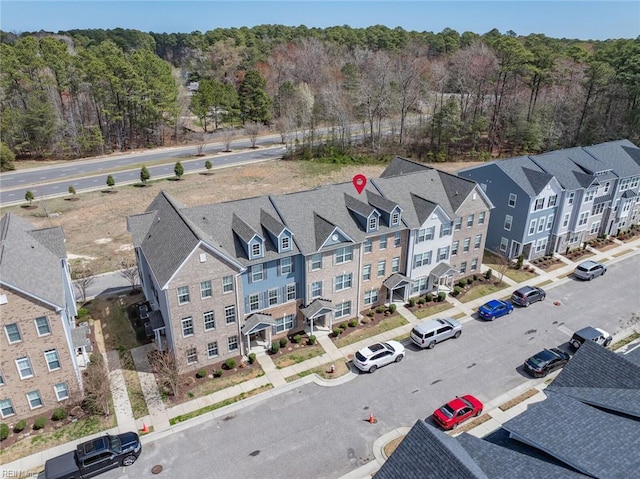 birds eye view of property with a view of trees