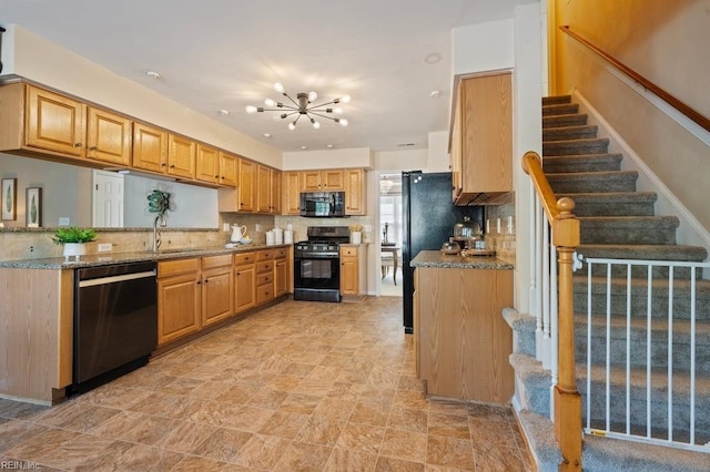 kitchen featuring a sink, black appliances, decorative backsplash, a notable chandelier, and light stone countertops