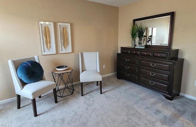 sitting room featuring baseboards and carpet flooring