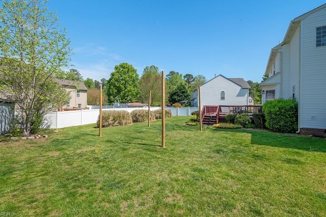 view of yard featuring fence and a deck